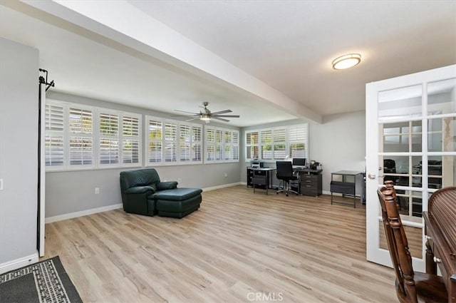 home office featuring light wood-type flooring, ceiling fan, and baseboards