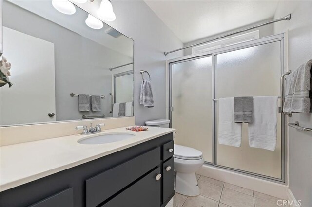 full bath featuring toilet, a stall shower, tile patterned flooring, and vanity