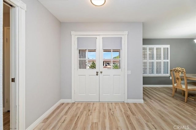 entryway with baseboards and light wood-style floors