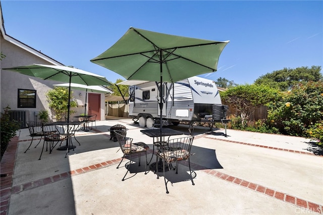 view of patio with fence and outdoor dining area