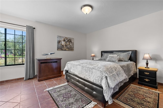 bedroom featuring baseboards and tile patterned flooring