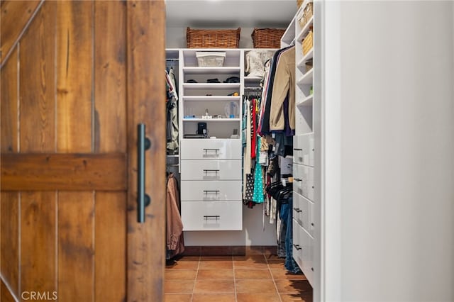 spacious closet featuring light tile patterned flooring