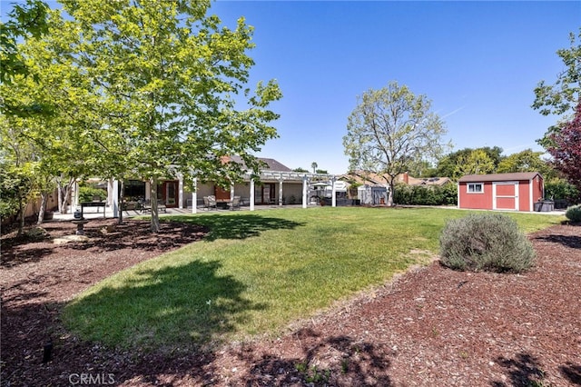 view of yard with an outbuilding, a storage shed, and a patio area