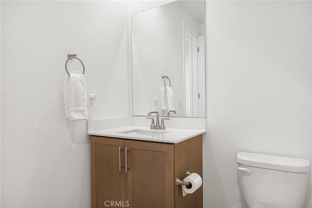 half bathroom featuring toilet and vanity