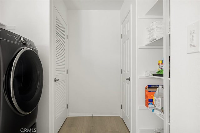 washroom with wood finished floors and washer / clothes dryer