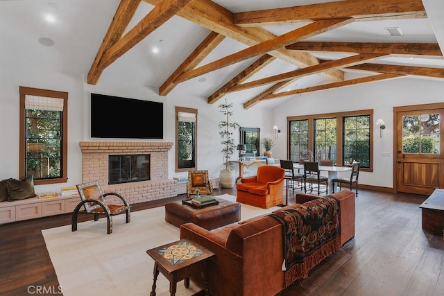 living area featuring wood finished floors, beam ceiling, a fireplace, baseboards, and recessed lighting