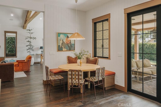 dining space with baseboards, beam ceiling, wood finished floors, and a wealth of natural light