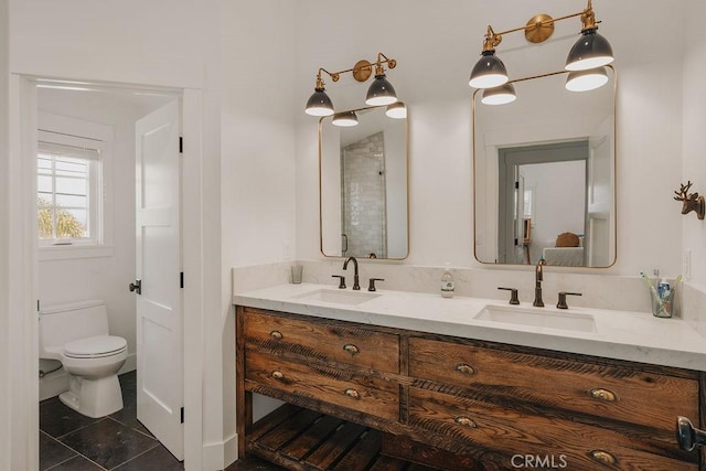 full bathroom featuring double vanity, toilet, a sink, and tile patterned flooring