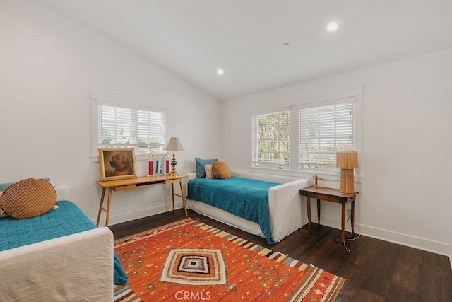 bedroom with multiple windows, vaulted ceiling, and wood finished floors