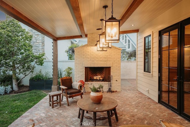 view of patio / terrace featuring fence and an outdoor brick fireplace