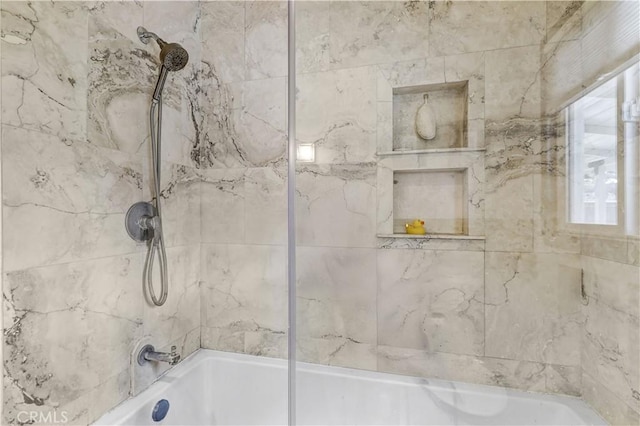 full bath featuring shower / bath combination and a wealth of natural light