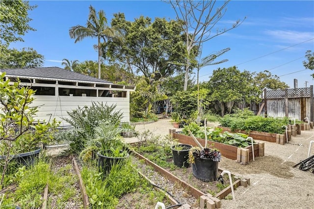view of yard with fence and a vegetable garden