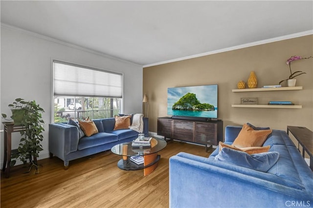 living area with crown molding and wood finished floors