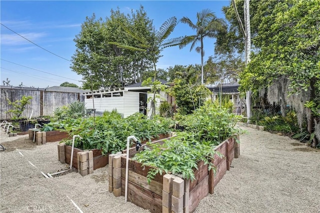 view of yard with fence and a vegetable garden