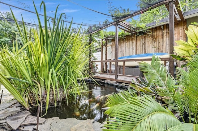 exterior details featuring a garden pond