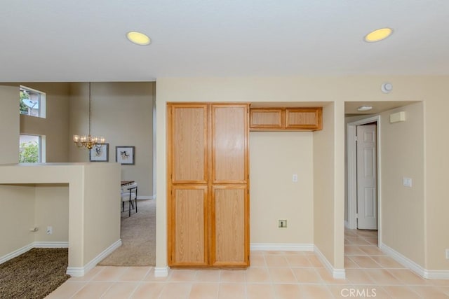 kitchen with recessed lighting, baseboards, and a notable chandelier