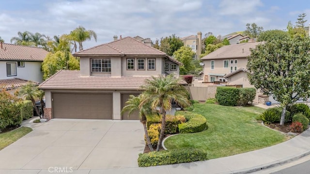 view of front of house with an attached garage, a front lawn, a tile roof, stucco siding, and driveway