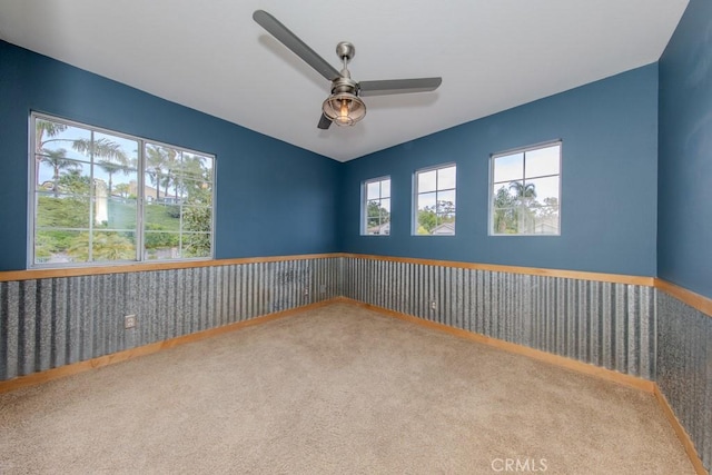 spare room featuring carpet flooring and ceiling fan