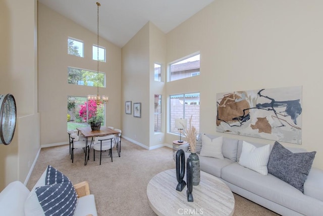 living area featuring baseboards, carpet flooring, a notable chandelier, and high vaulted ceiling
