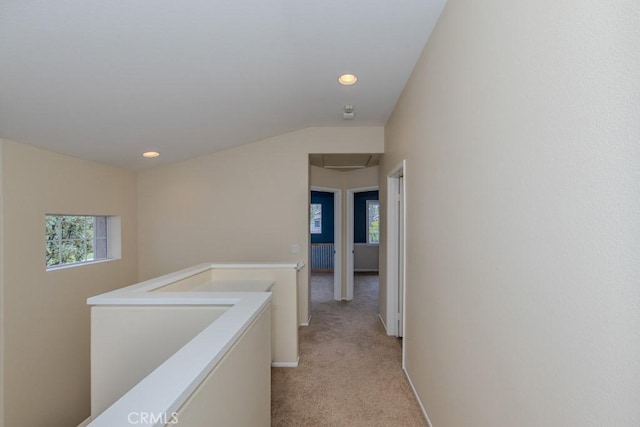 hallway featuring attic access, an upstairs landing, lofted ceiling, light carpet, and recessed lighting