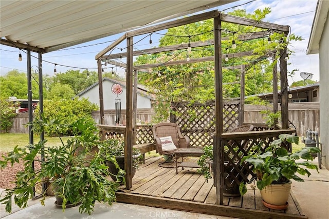 wooden deck with a fenced backyard