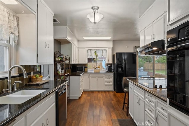 kitchen featuring white cabinetry, black appliances, under cabinet range hood, and a sink