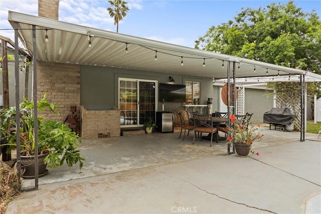 rear view of house with a patio and outdoor dining area