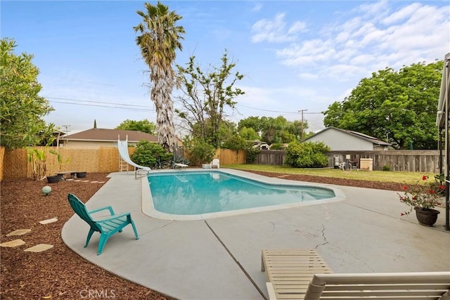 view of pool with a fenced in pool, a water slide, a patio, and a fenced backyard
