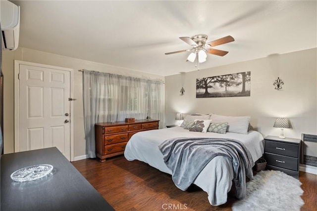 bedroom with a ceiling fan, dark wood-style flooring, and an AC wall unit