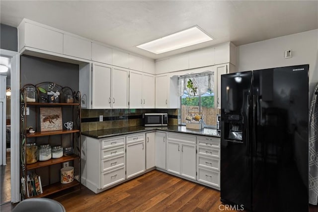 kitchen featuring dark countertops, black fridge with ice dispenser, dark wood-style floors, and white cabinetry