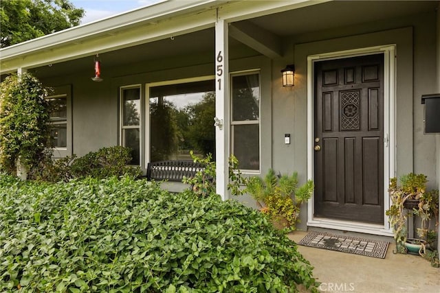 view of exterior entry featuring a porch