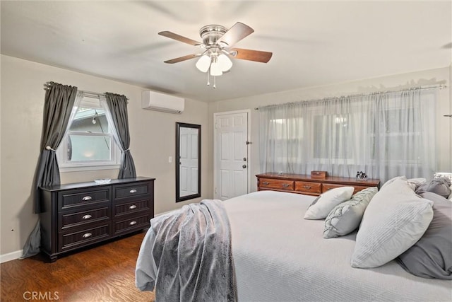bedroom with baseboards, a wall mounted air conditioner, a ceiling fan, and dark wood-style flooring