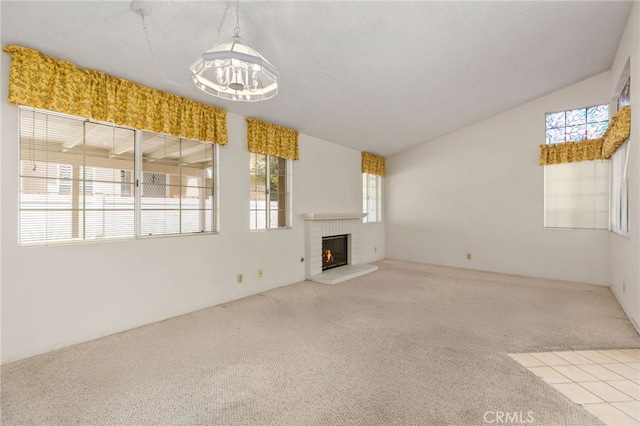 819 Miller Rd, Banning, CA 92220 - unfurnished living room featuring an inviting chandelier, carpet, lofted ceiling, and a brick fireplace