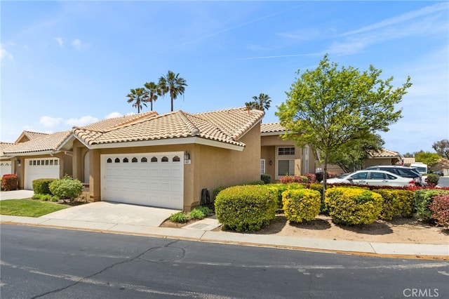 819 Miller Rd, Banning, CA 92220 - view of front facade featuring a garage, concrete driveway, stucco siding, and a tiled roof