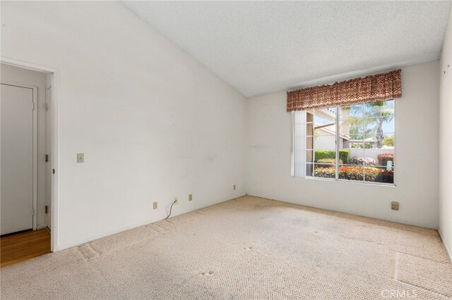 819 Miller Rd, Banning, CA 92220 - carpeted spare room with a textured ceiling and vaulted ceiling