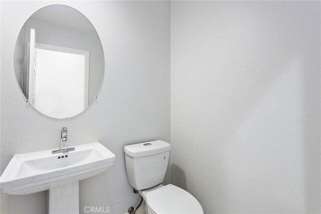 half bath with toilet and a sink
