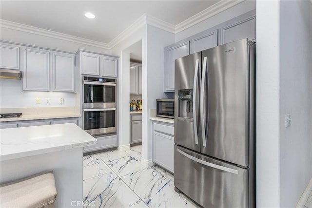 kitchen with appliances with stainless steel finishes, light stone countertops, ornamental molding, marble finish floor, and gray cabinets
