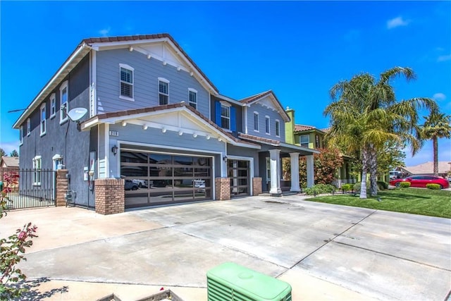 view of front of property with driveway, a garage, fence, and brick siding
