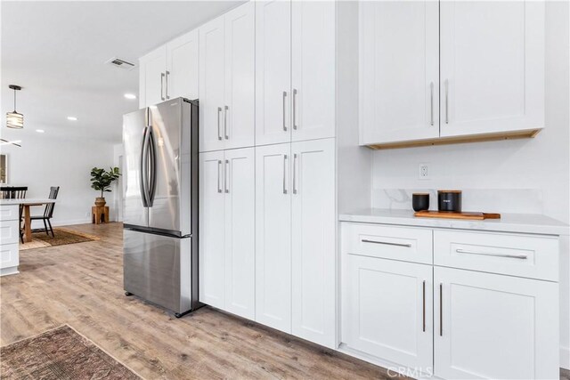40 Frontier Way, Templeton, CA 93465 - kitchen with recessed lighting, freestanding refrigerator, light wood-style floors, white cabinets, and visible vents