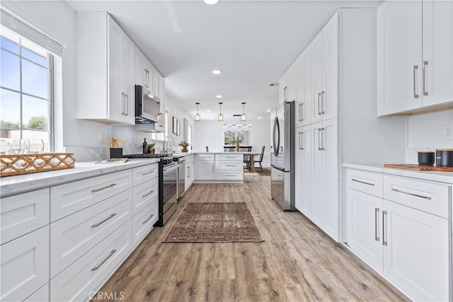 40 Frontier Way, Templeton, CA 93465 - kitchen with white cabinetry, light wood-style floors, stainless steel appliances, recessed lighting, and a peninsula