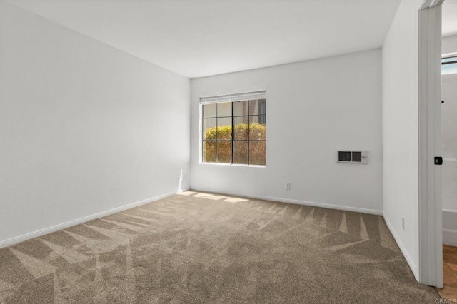 spare room with carpet floors and baseboards