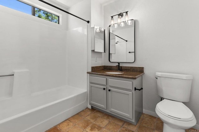 full bath featuring vanity, toilet, tub / shower combination, and baseboards