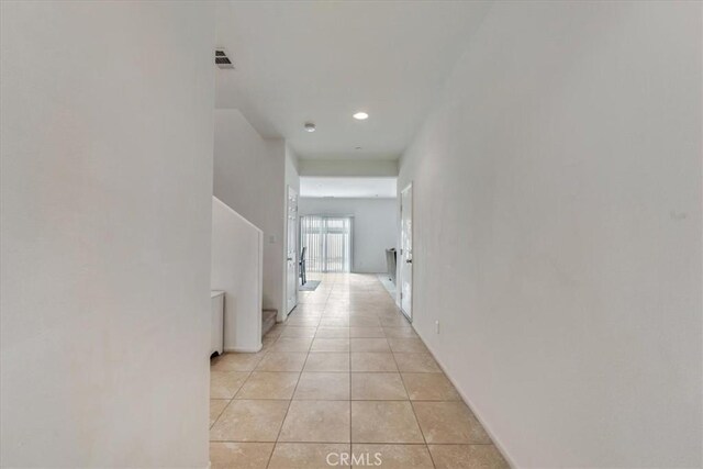 corridor featuring visible vents, recessed lighting, and light tile patterned floors