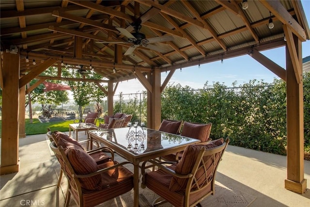 view of patio / terrace featuring a gazebo, outdoor dining space, and a ceiling fan