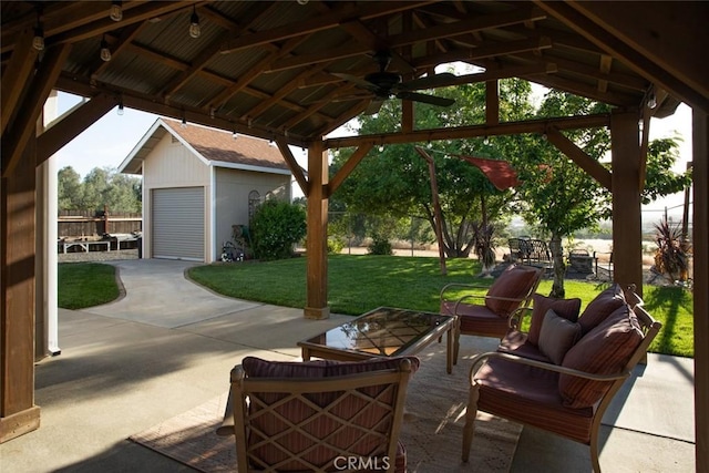 view of patio featuring a gazebo, outdoor lounge area, an outbuilding, fence, and a ceiling fan