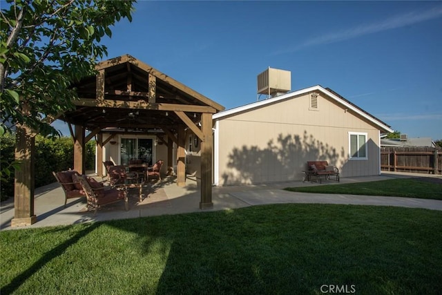 back of house featuring a yard, a patio, a gazebo, and fence