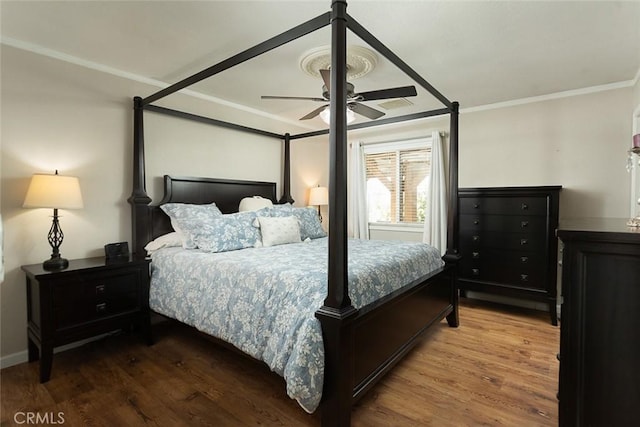 bedroom with wood finished floors, a ceiling fan, and ornamental molding