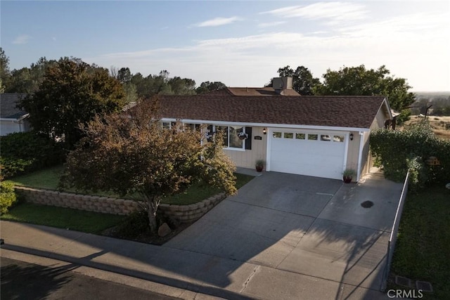 single story home featuring a garage and concrete driveway