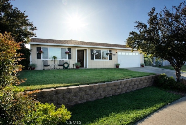ranch-style house featuring a front yard, driveway, and a garage