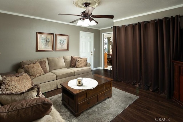 living area featuring crown molding, dark wood-style floors, and ceiling fan